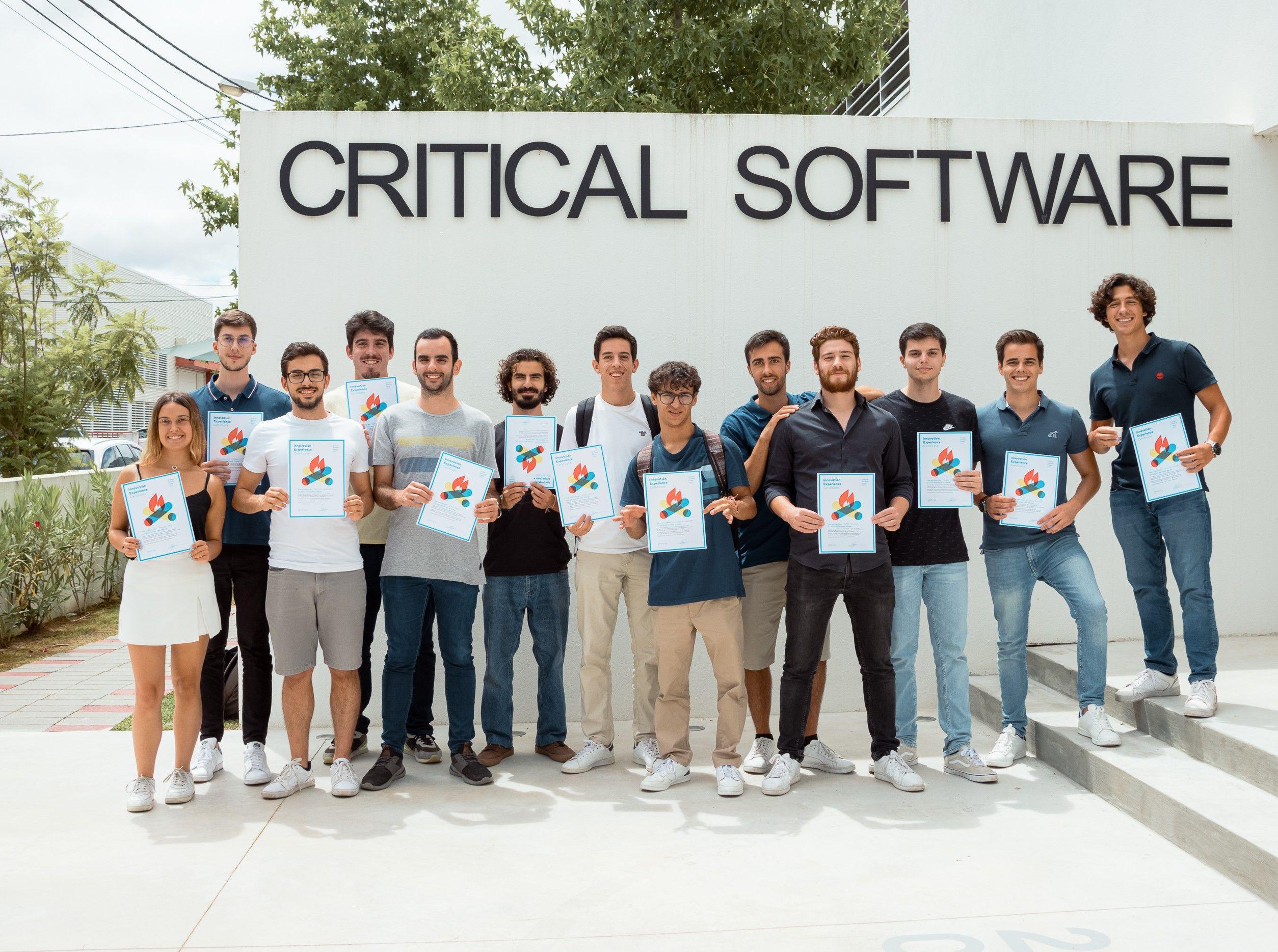 Students in front of Critical Software's headquarters with their summer camp certificates
