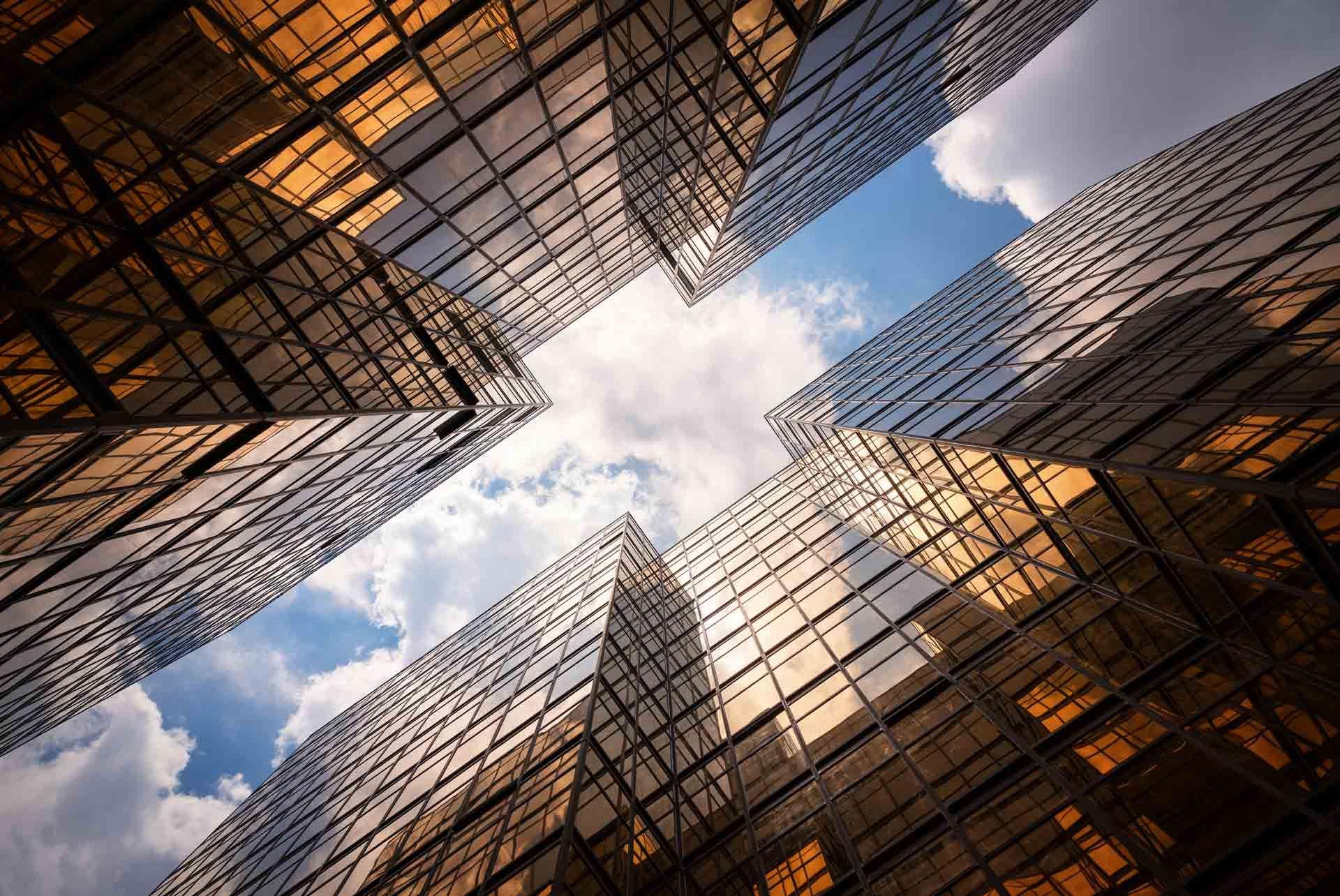 ground-view looking up to the clouds in between two skyscrapers 