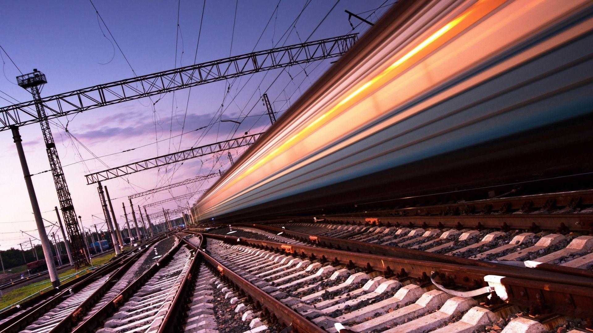 train tracks with train passing by