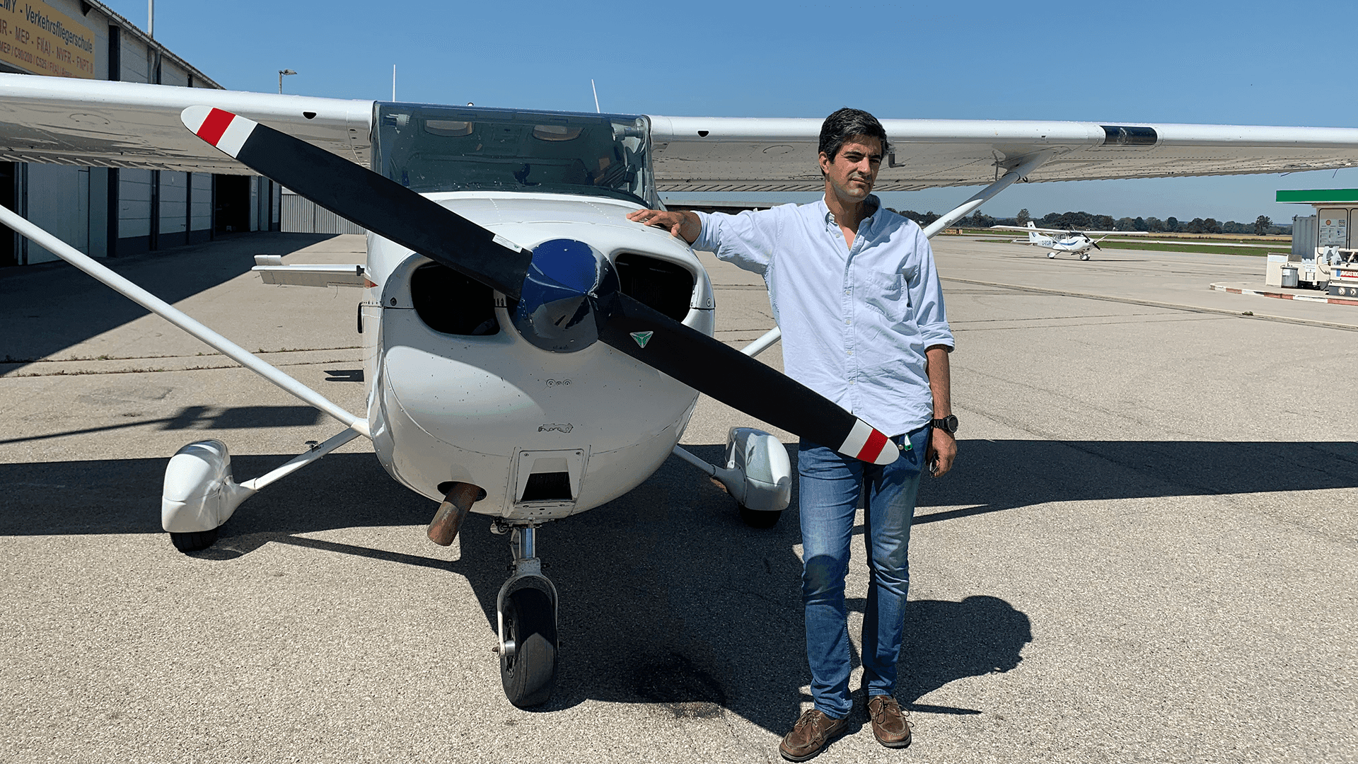 person standing next to a small airplane