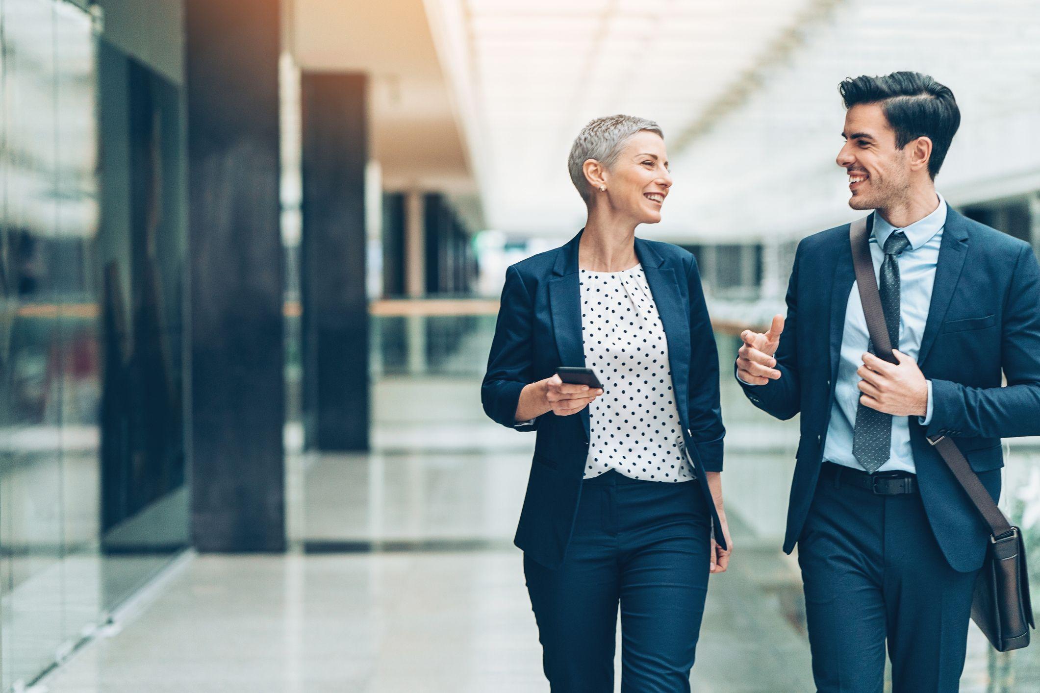 Two business people walking and having a conversation