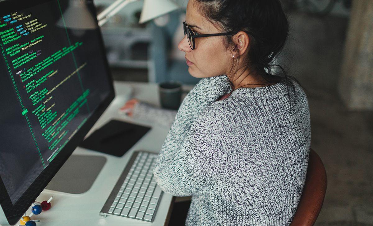 Woman writing code on Computer