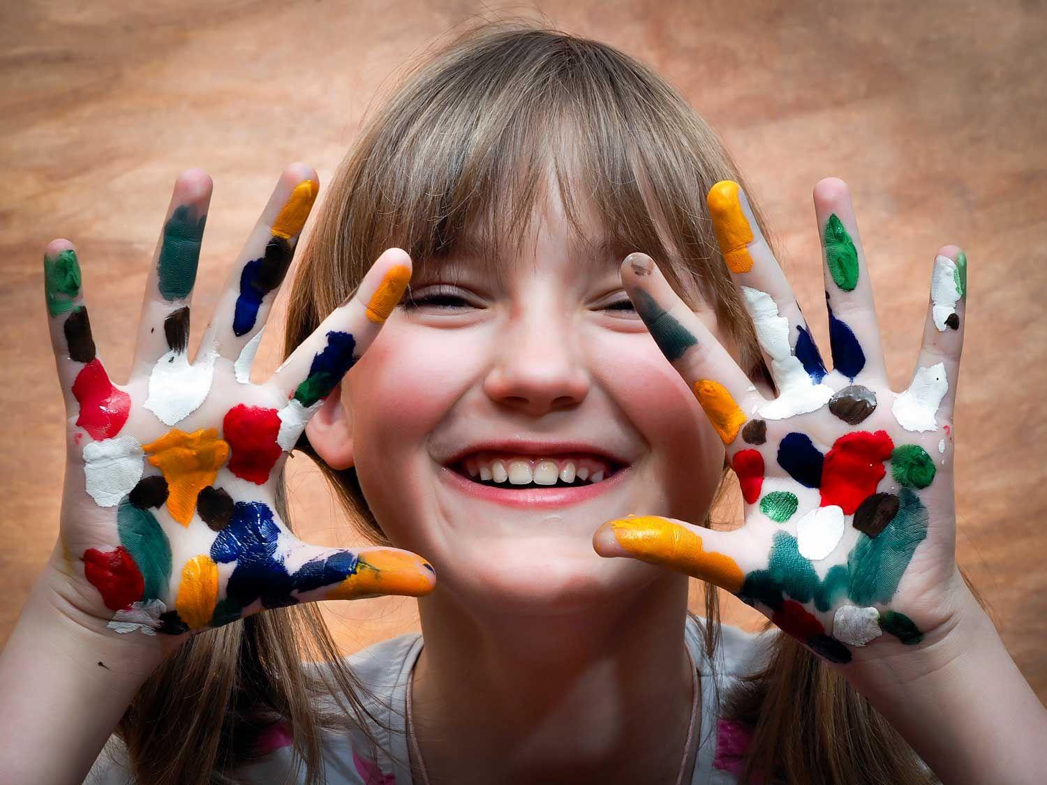 Little girl with color on her hands