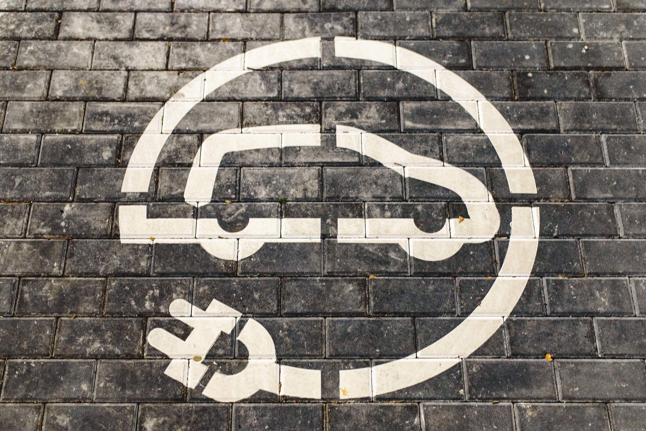 Electric vehicles icon on grey bricks